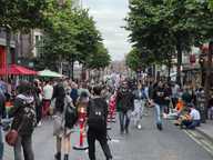 traffic-free parliament street in dublin with people walking around and sitting outside bars